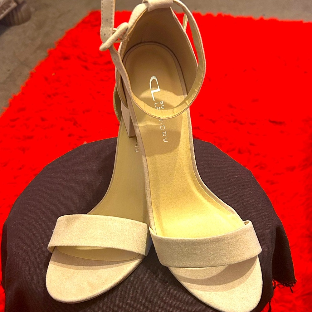 Ladies ankle strap shoes in a cream color with 2 1/2 inch heel